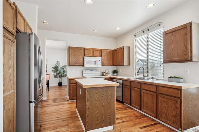 4290 Cottonwood Lakes Blvd, Thornton, CO 80241 - kitchen with a sink, light wood-style flooring, appliances with stainless steel finishes, and light countertops