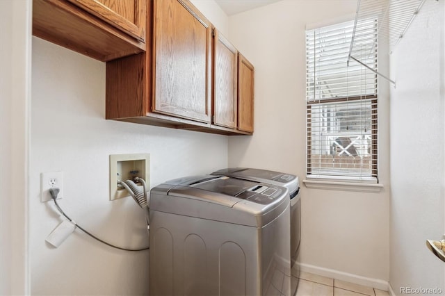 4290 Cottonwood Lakes Blvd, Thornton, CO 80241 - washroom with cabinet space, baseboards, light tile patterned floors, and washer and dryer