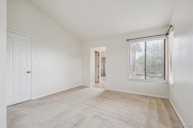 4290 Cottonwood Lakes Blvd, Thornton, CO 80241 - spare room with baseboards, visible vents, light carpet, and vaulted ceiling