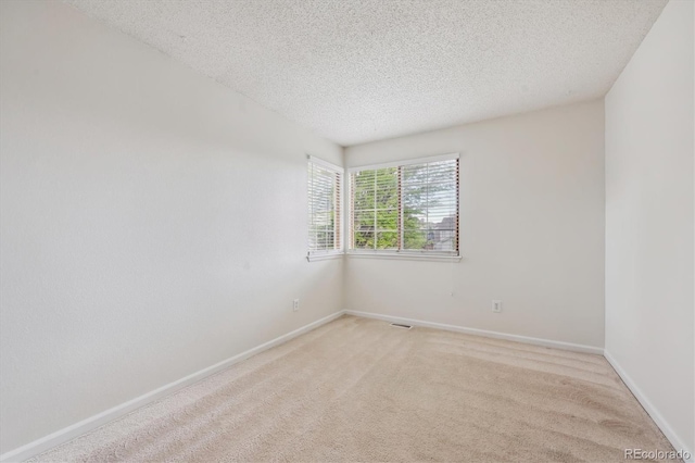 4290 Cottonwood Lakes Blvd, Thornton, CO 80241 - spare room with a textured ceiling, light colored carpet, and baseboards