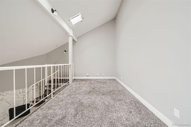 interior space featuring carpet flooring and vaulted ceiling with beams