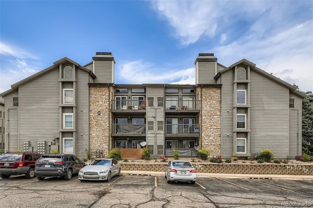 2575 S Syracuse Way Unit B107, Denver, CO 80231 - view of building exterior featuring uncovered parking