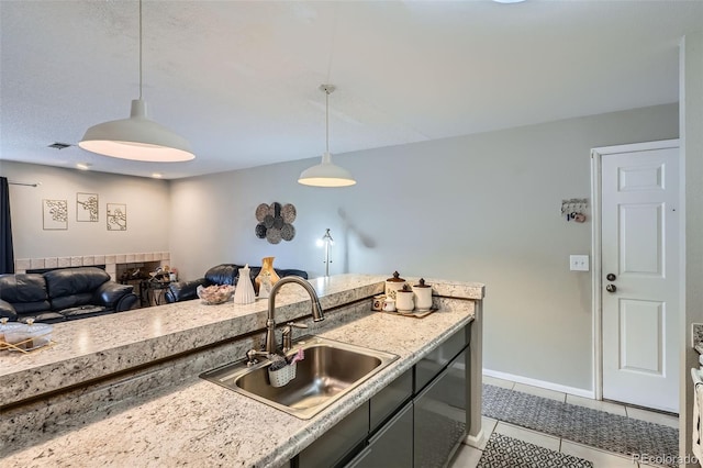 2575 S Syracuse Way Unit B107, Denver, CO 80231 - kitchen featuring decorative light fixtures, light countertops, light tile patterned floors, and open floor plan