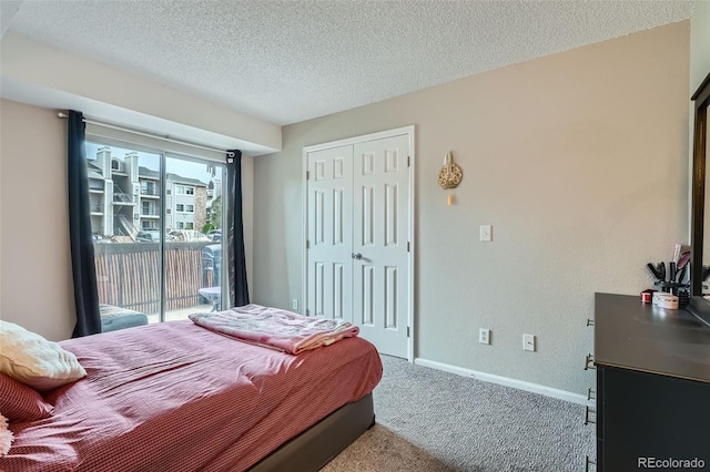 2575 S Syracuse Way Unit B107, Denver, CO 80231 - carpeted bedroom featuring access to exterior, a closet, and a textured ceiling