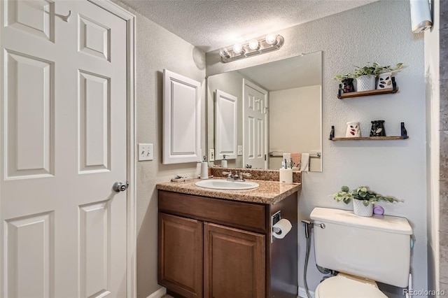 2575 S Syracuse Way Unit B107, Denver, CO 80231 - bathroom with vanity, a textured ceiling, and a textured wall