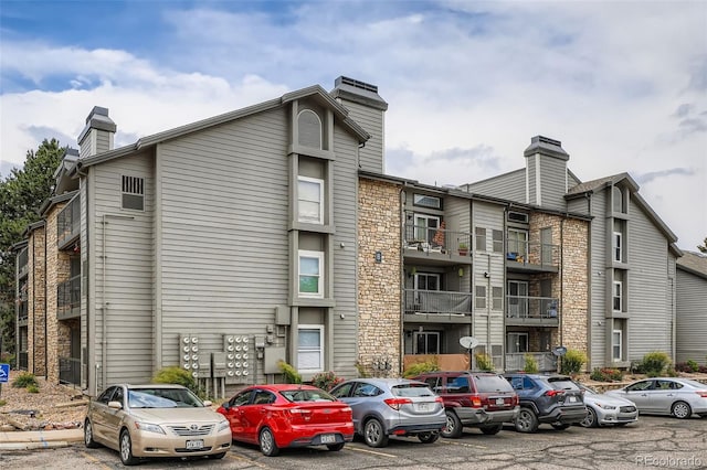 2575 S Syracuse Way Unit B107, Denver, CO 80231 - view of building exterior featuring uncovered parking