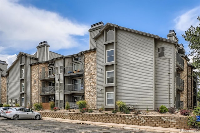 2575 S Syracuse Way Unit B107, Denver, CO 80231 - view of property featuring uncovered parking