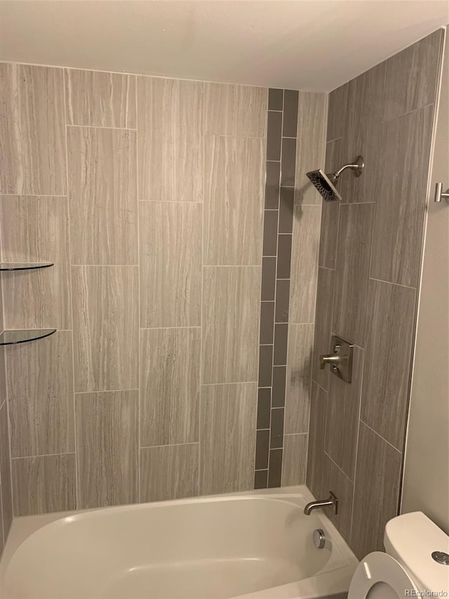 bathroom with bathing tub / shower combination and toilet