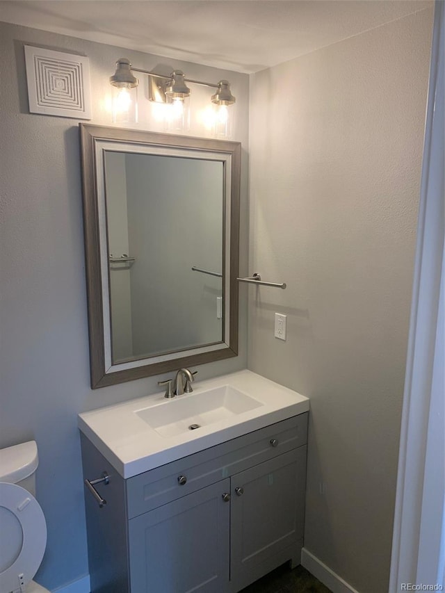 bathroom with toilet and vanity