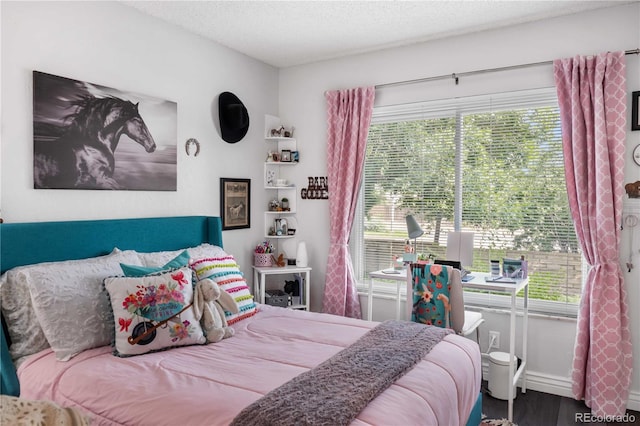 bedroom featuring a textured ceiling and hardwood / wood-style floors