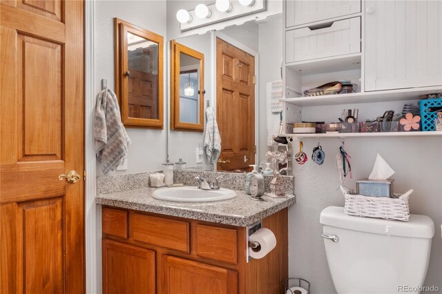 bathroom with toilet and vanity