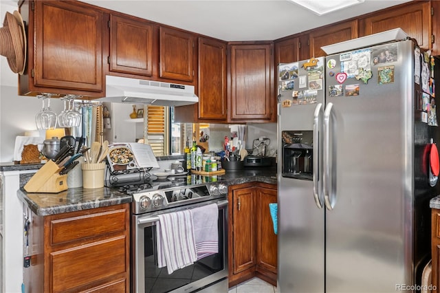 kitchen featuring dark stone countertops and appliances with stainless steel finishes