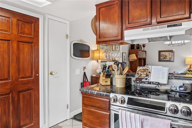 kitchen featuring double oven range and light tile patterned floors