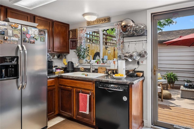 kitchen with sink, light tile patterned flooring, dishwasher, and stainless steel fridge with ice dispenser