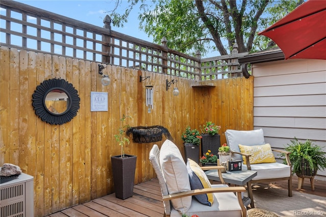 wooden deck featuring central AC unit