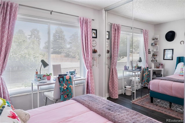 bedroom featuring a textured ceiling and wood-type flooring