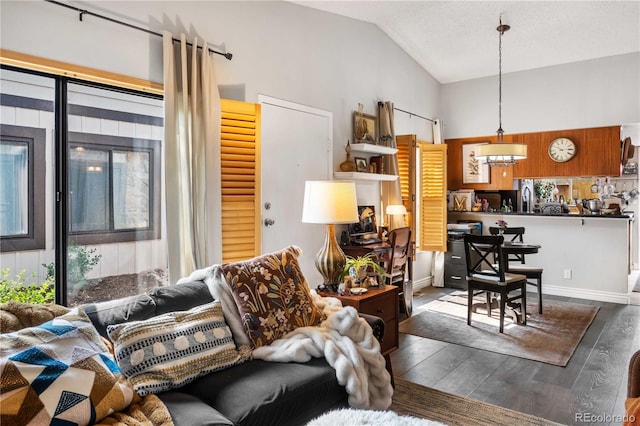 living room featuring hardwood / wood-style flooring, lofted ceiling, and sink