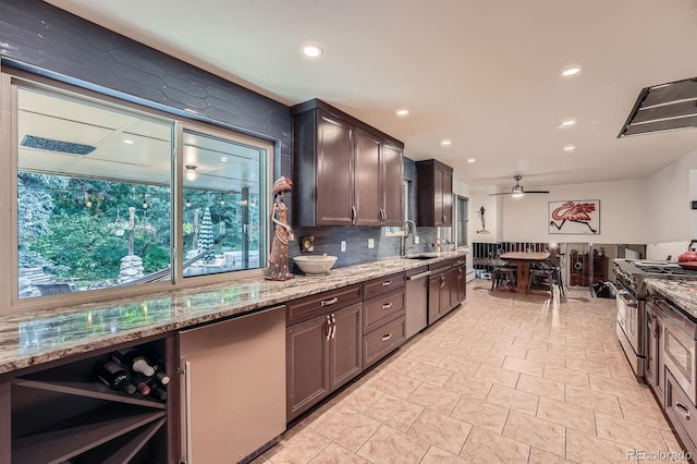 7875 W 21st Ave, Lakewood, CO 80214 - kitchen featuring appliances with stainless steel finishes, light stone counters, ceiling fan, tasteful backsplash, and dark brown cabinetry