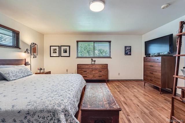 7875 W 21st Ave, Lakewood, CO 80214 - bedroom featuring light wood-style flooring and baseboards
