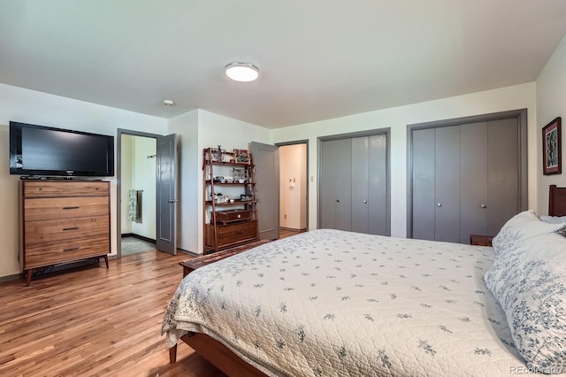 7875 W 21st Ave, Lakewood, CO 80214 - bedroom featuring multiple closets, light wood finished floors, and ensuite bathroom