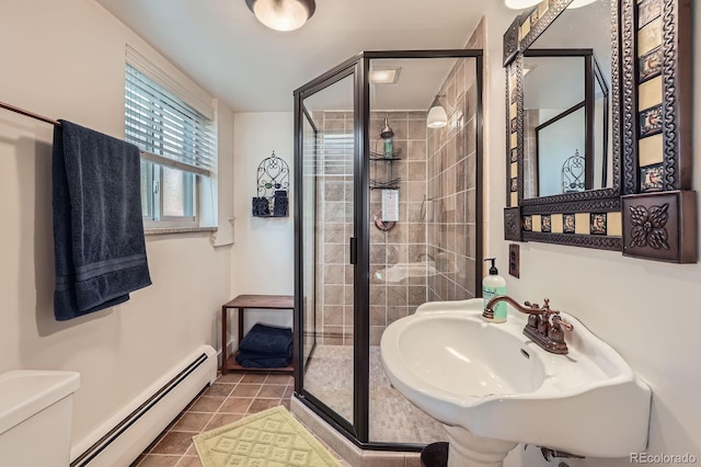 7875 W 21st Ave, Lakewood, CO 80214 - full bath featuring a baseboard radiator, a shower stall, and tile patterned floors