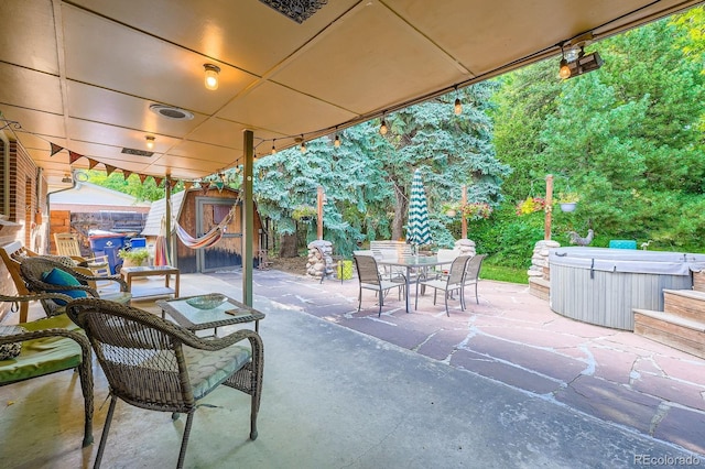 7875 W 21st Ave, Lakewood, CO 80214 - view of patio / terrace featuring a hot tub, a storage unit, and outdoor dining area