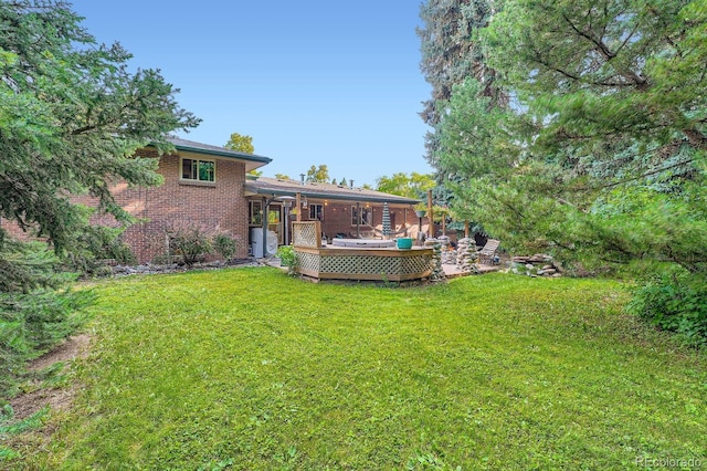 7875 W 21st Ave, Lakewood, CO 80214 - rear view of property with a lawn, brick siding, and a wooden deck