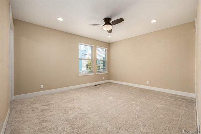 carpeted empty room featuring ceiling fan