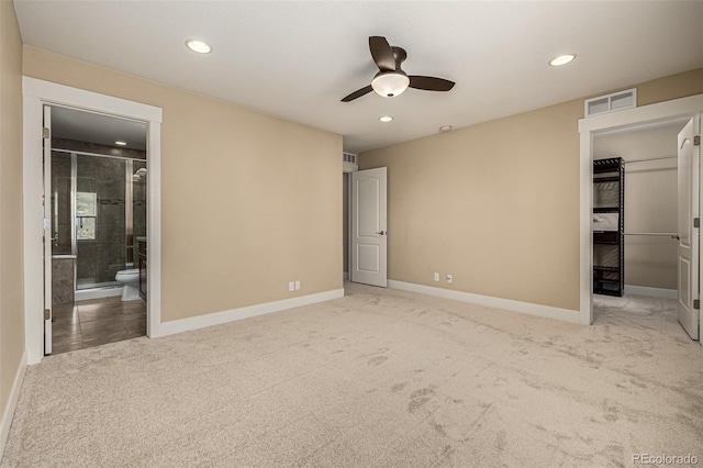 unfurnished bedroom featuring visible vents, connected bathroom, baseboards, and carpet