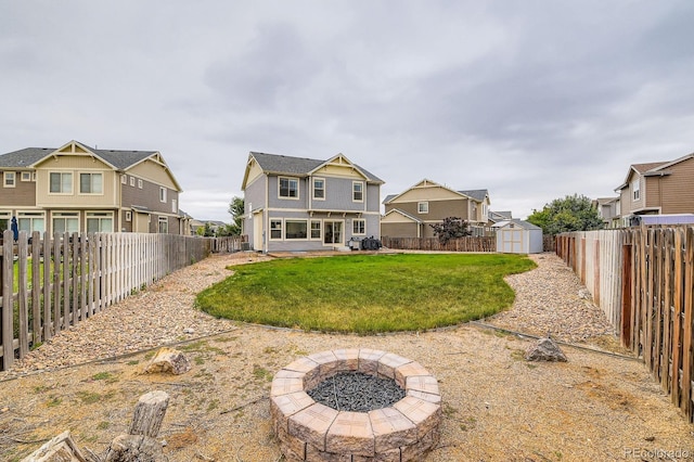 12981 E 108th Way, Commerce City, CO 80022 - rear view of property featuring a fire pit, a residential view, a shed, and a fenced backyard