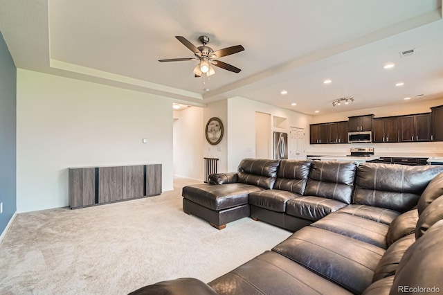 12981 E 108th Way, Commerce City, CO 80022 - living room with a ceiling fan, light colored carpet, a tray ceiling, and recessed lighting