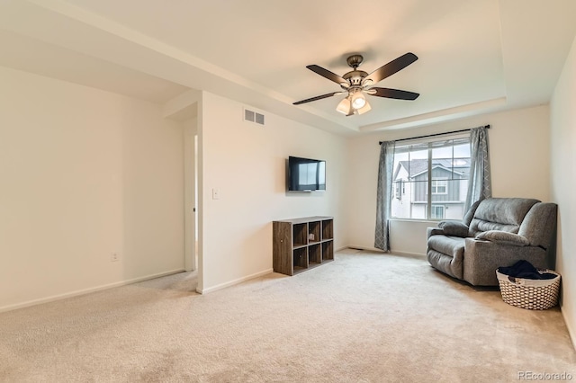 12981 E 108th Way, Commerce City, CO 80022 - sitting room featuring a ceiling fan, a raised ceiling, and light colored carpet