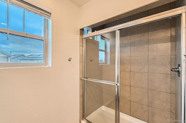 12981 E 108th Way, Commerce City, CO 80022 - bathroom featuring a shower stall and a textured wall