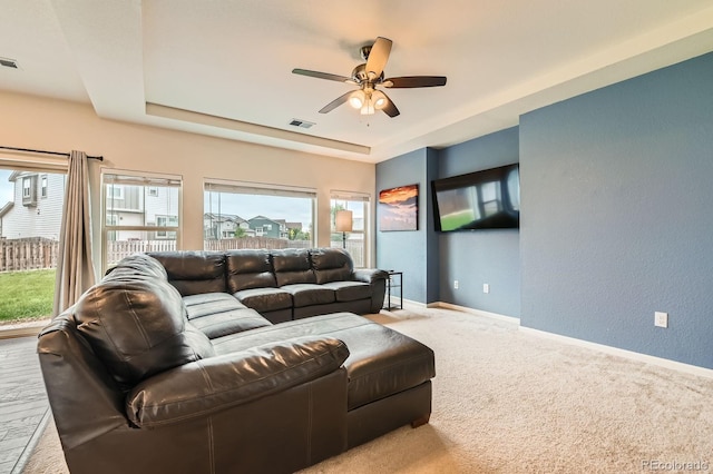 12981 E 108th Way, Commerce City, CO 80022 - carpeted living area with a tray ceiling, a ceiling fan, and a textured wall