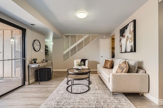 living area with wood finished floors and baseboards