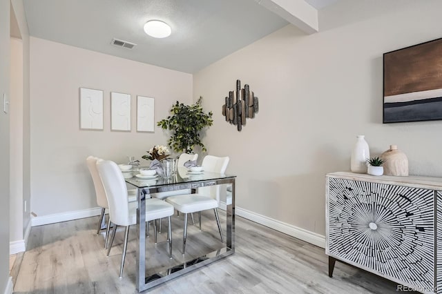 dining area featuring wood finished floors and baseboards