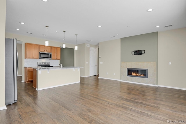 kitchen with visible vents, open floor plan, light countertops, dark wood-style floors, and stainless steel appliances