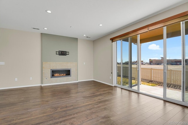 unfurnished living room featuring recessed lighting, visible vents, wood finished floors, and a tile fireplace