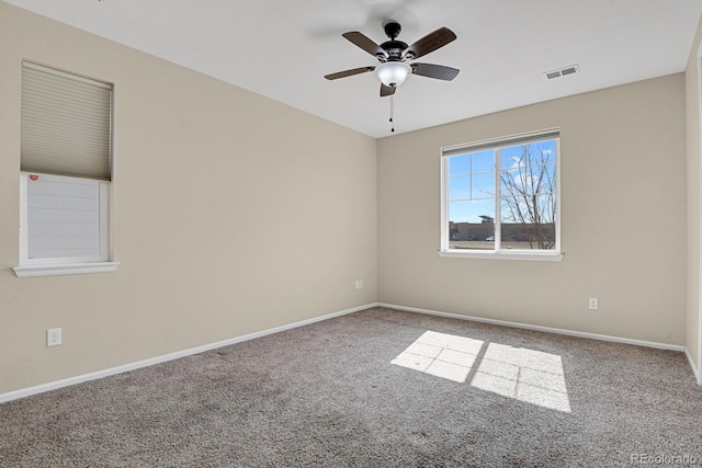 spare room featuring visible vents, ceiling fan, baseboards, and carpet