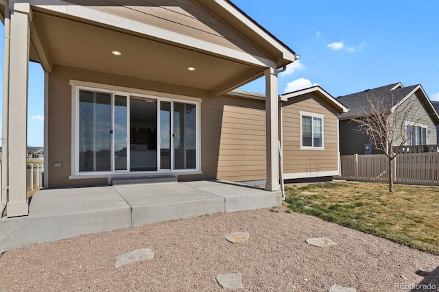 back of house with a patio area, a lawn, and fence