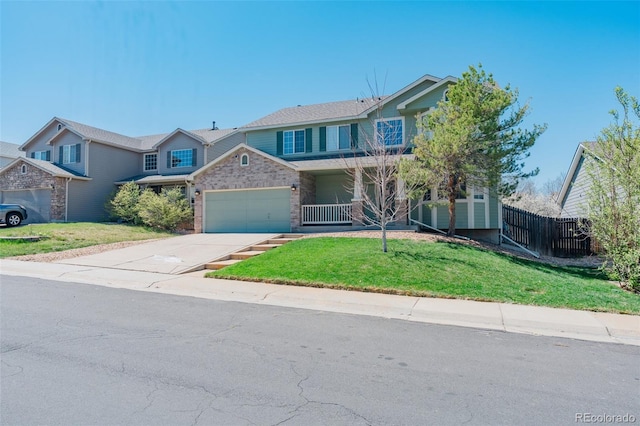 view of front facade featuring fence, an attached garage, a front yard, and concrete driveway