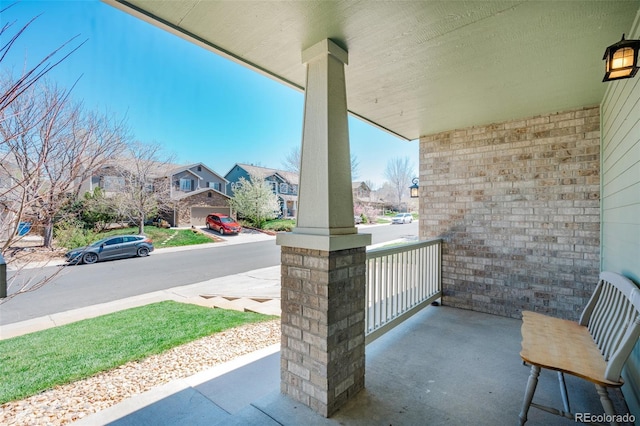 view of patio featuring covered porch and a residential view