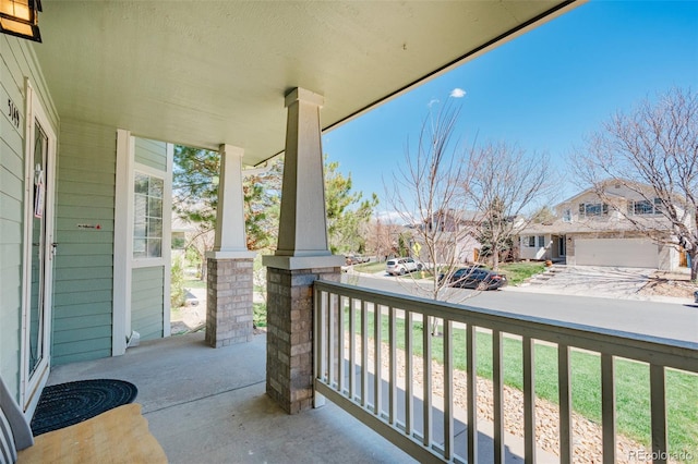 balcony featuring a porch and a residential view