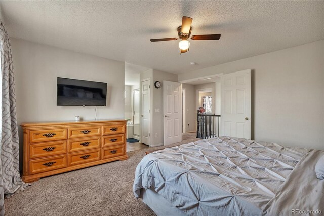bedroom with light carpet, ensuite bath, a textured ceiling, and ceiling fan