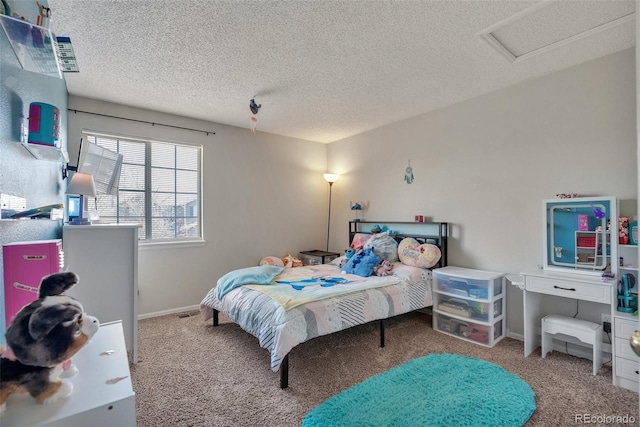 carpeted bedroom with attic access, a textured ceiling, and baseboards