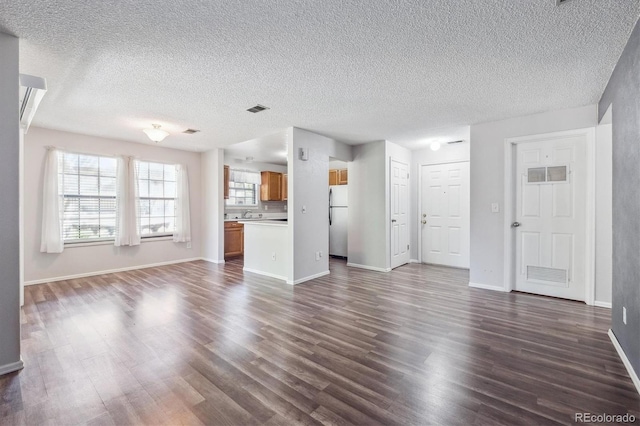 10950 W Florida Ave Unit 314, Lakewood, CO 80232 - unfurnished living room with dark wood-type flooring and a textured ceiling