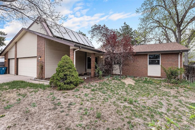 single story home featuring brick siding, a garage, a porch, and concrete driveway