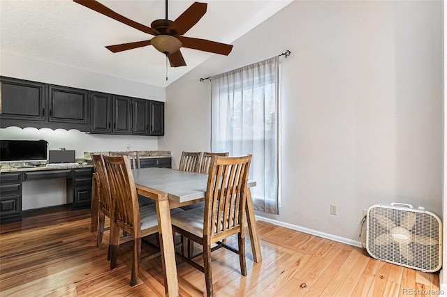 dining space featuring ceiling fan, vaulted ceiling, plenty of natural light, and baseboards