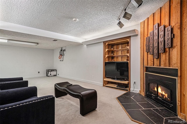 carpeted living room with a warm lit fireplace and a textured ceiling