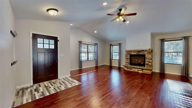 entryway featuring vaulted ceiling, hardwood / wood-style flooring, ceiling fan, a fireplace, and a wealth of natural light